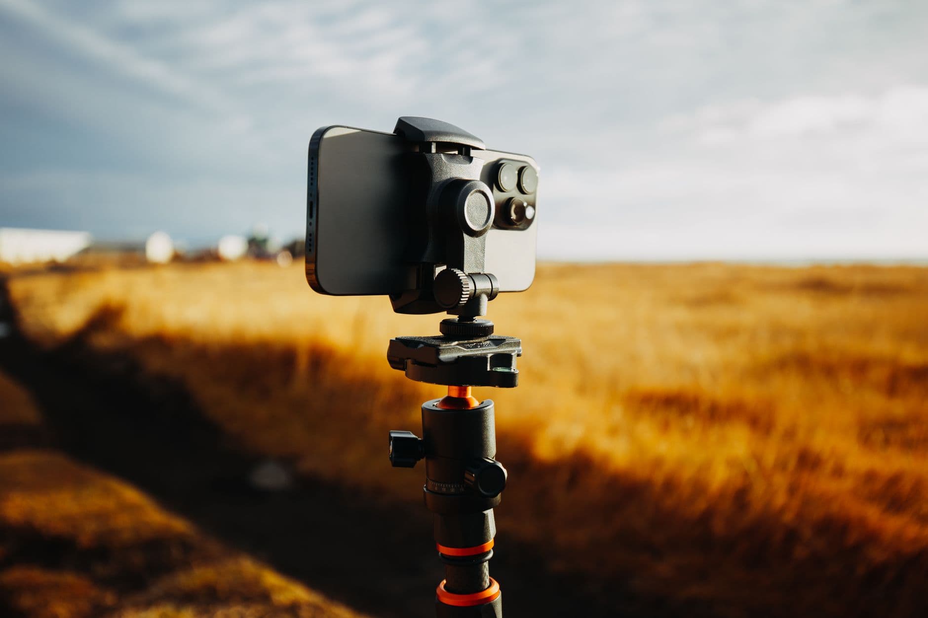 An iPhone mounted on a tripod, filming outdoors